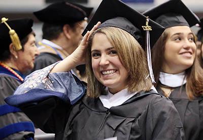 Graduate adjusting her cap